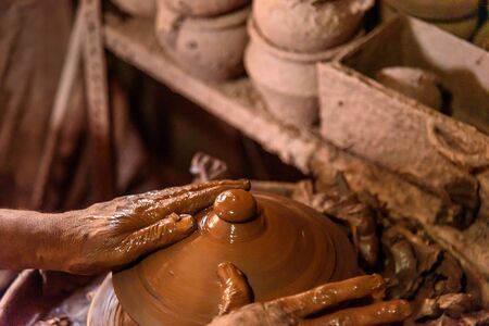 Indian potter making clay pots on pottery wheel in Dharavi Slum at Mumbai. Indiaの写真素材