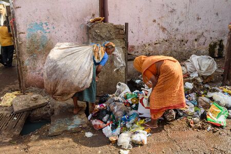 Mumbai, India - February 26, 2019: Indian women sorting garbage in Dharavi Slum at Mumbaiのeditorial素材