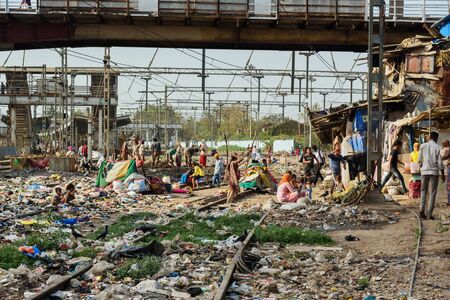 Mumbai, India - February 26, 2019: View of garbage slums poor area near Suburban Railway. Dharavi...