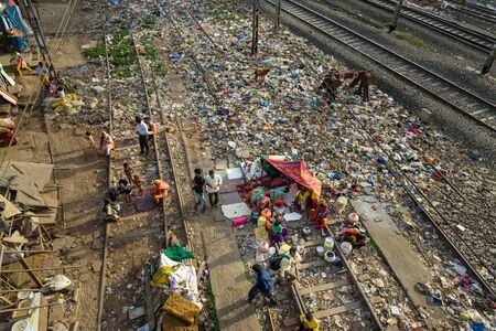 Mumbai, India - February 26, 2019: Indian people on railroad near Suburban Railway in Dharavi Slum at Mumbai. Top viewのeditorial素材