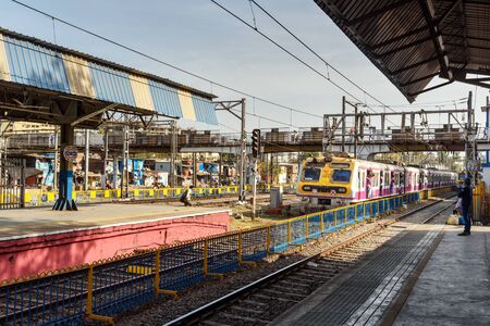 Mumbai, India - February 26, 2019: Local train arriving at railway station. Mumbai Suburban Railwayのeditorial素材