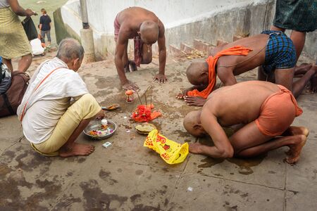 Kolkata, India - March 12, 2019: Indian people perform Hindu religious rituals near Hooghly or Ganga...