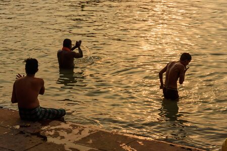 Kolkata, India - March 11, 2019: Indian people bathing in river Hooghly or Ganga at Mallick ghat in sunsetのeditorial素材