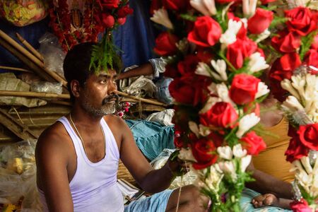 Kolkata, India - March 11, 2019: Indian seller on Flower market at Mallick Ghat in Kolkataのeditorial素材