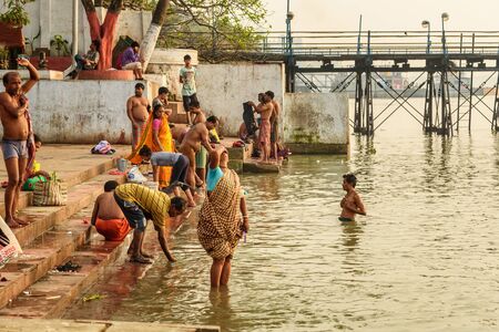 Kolkata, India - March 11, 2019:Indian people bathing in river Hooghly or Ganga at Mallick ghat in...