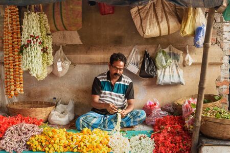 Kolkata, India - March 12, 2019: Indian seller on Flower market at Mallick Ghat in Kolkata