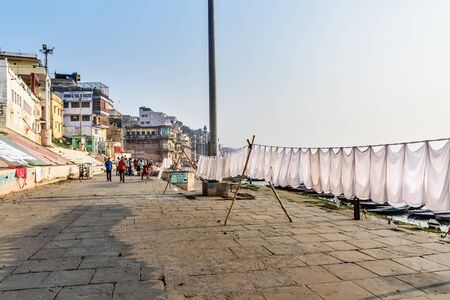 Varanasi, India - March 18, 2019: Laundry drying on rope on Ghat in sunny day at Varanasi