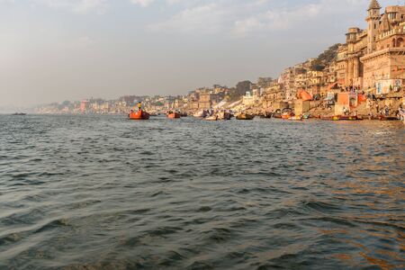Varanasi, India - March 18, 2019: View of Munshi Ghat and Ghats on Ganges river from boat