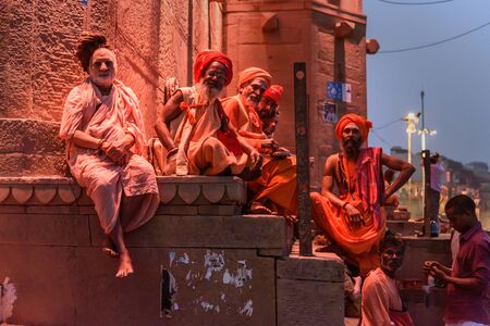 Varanasi, India - March 18, 2019: Group of Indian Sadhu holy men in Raja Ghat in the nightのeditorial素材