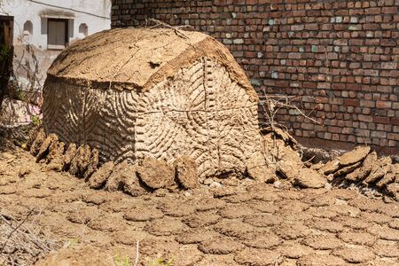 Small hut that are built to store cow or buffalo dung that will be used later as traditional cooking fuel on hearths. Nandgaon.Uttar Pradesh. Indiaの写真素材
