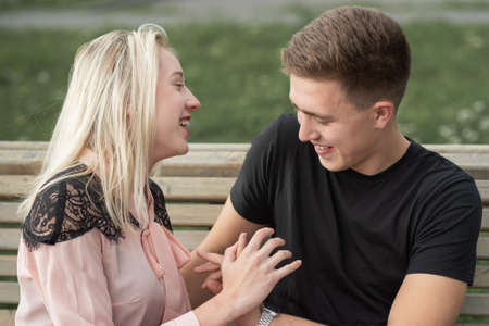 Happy couple in love looking at each other and having fun on the street in sity