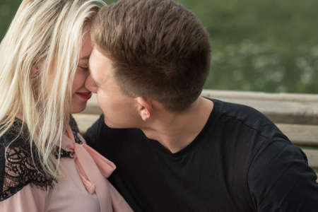 Young romantic couple is kissing on the streetの写真素材