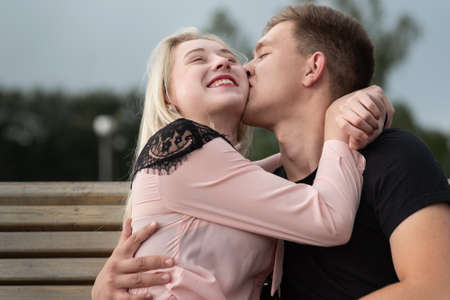 Young romantic couple is kissing on the street