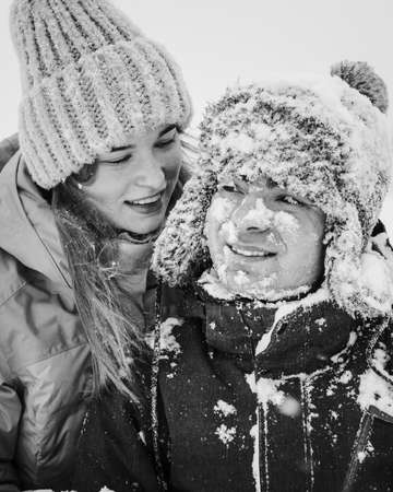 Portrait of smiling couple in love. Young happy couple walking in winter day. Black and white