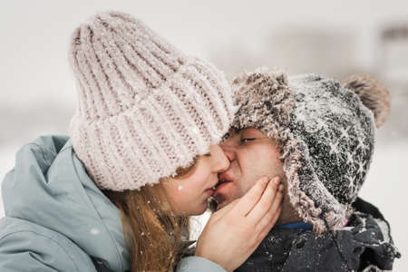 Portrait of smiling couple in love. Young happy couple walking in winter day