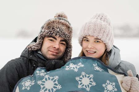 Portrait of smiling couple in love. Young happy couple walking in winter dayの写真素材