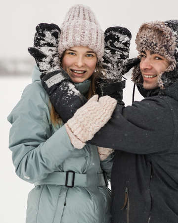 Portrait of smiling couple in love. Young happy couple walking in winter dayの写真素材