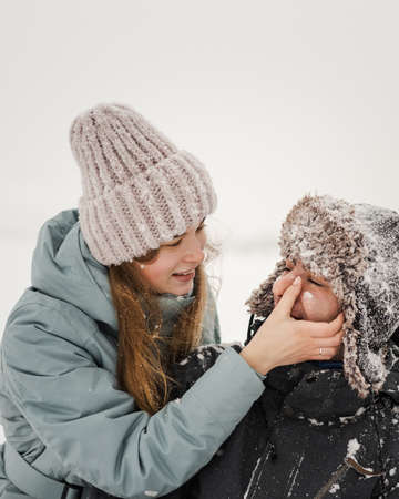 Portrait of smiling couple in love. Young happy couple walking in winter dayの写真素材