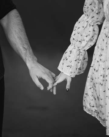 Couple standing side by side and holding outside. Blck and whiteの写真素材