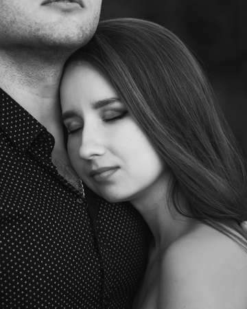 Close up sensual portrait of young couple in love outside. Black and whiteの写真素材