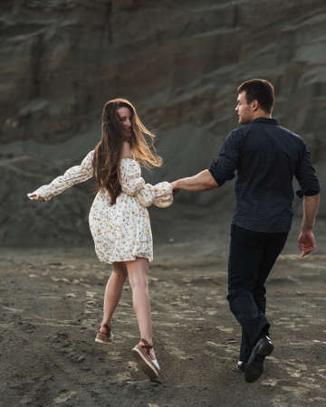 Couple of lovers holding hands and running away in sunny dayの写真素材