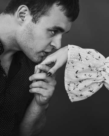 Man kissing his woman's hand. Black and whiteの写真素材