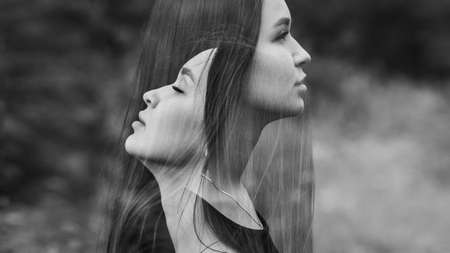 Emotional woman portrait outdoors. Creative. Double exposure. Black and white.の写真素材