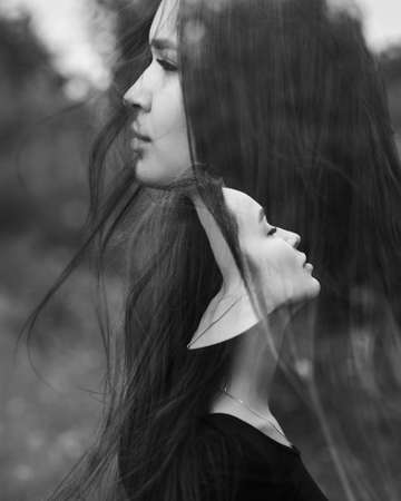 Emotional woman portrait outdoors. Creative. Double exposure. Black and white.の写真素材