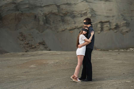 Romantic couple blindfolded with black ribbon. Love blind conceptの写真素材