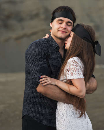 Romantic couple blindfolded with black ribbon. Love blind conceptの写真素材