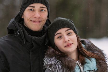 Portrait of couple of teenagers in winter forestの写真素材