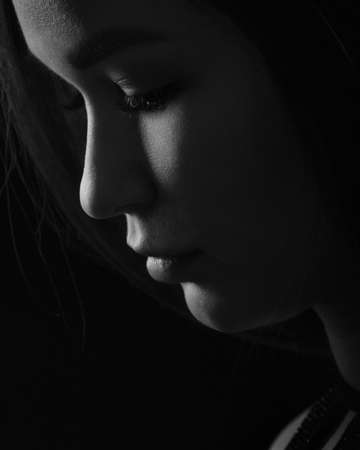 Profile sensually portrait of pretty woman on black background. Black and whiteの写真素材