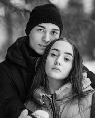 Portrait of couple of teenagers in winter forest. Black and whiteの写真素材