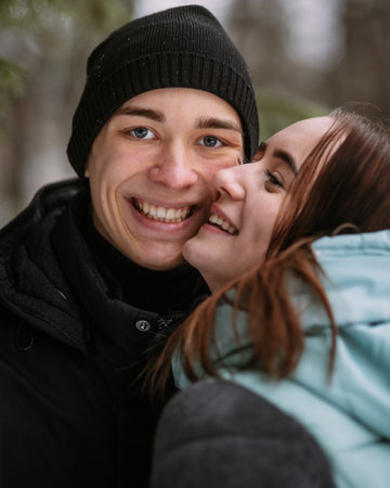 Portrait of couple of teenagers in winter forestの写真素材