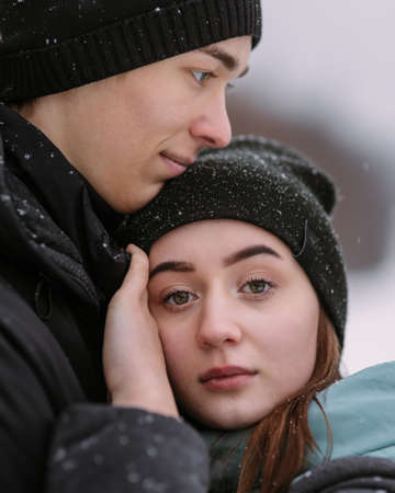 Portrait of couple of teenagers in winter forestの写真素材