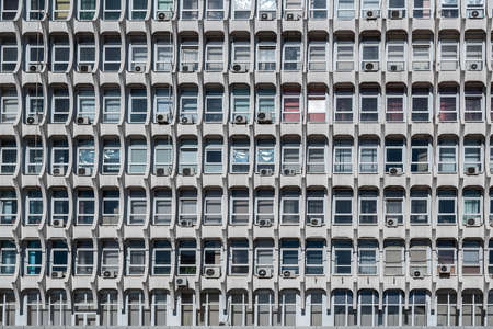 Soviet architecture. Facade of gray building with windows backgroundの写真素材