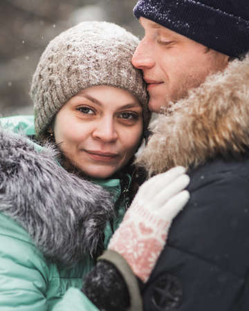 Portrait of young couple in winter forestの写真素材