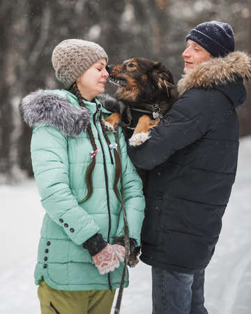 Portrait of young couple in winter forestの写真素材