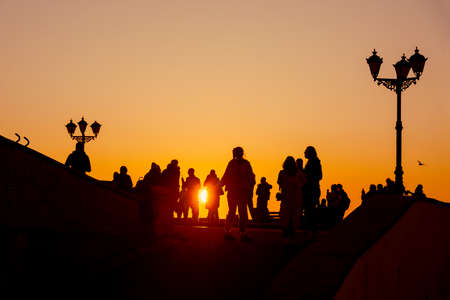Silhouette of a group of people against the sunset on embankment of Sevastopol. Crimeaの写真素材