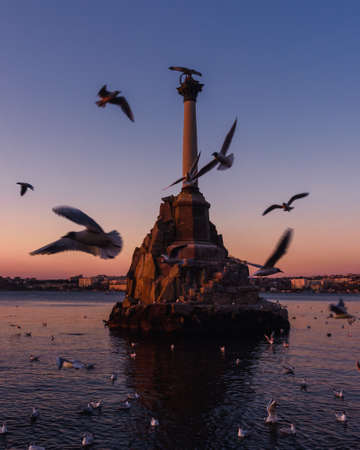 Sunset on the embankment of Sevastopol. Monument to sunken ships against the sun. Sevastopol, Crimeaの写真素材