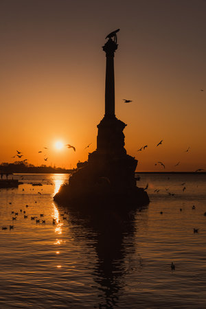 Sunset on the embankment of Sevastopol. Monument to sunken ships against the sun. Sevastopol, Crimeaの写真素材