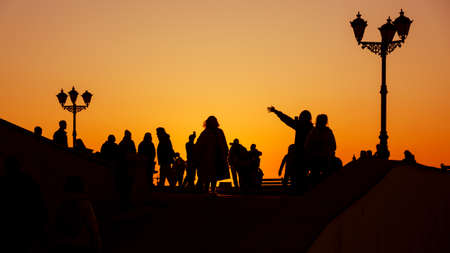 Silhouette of a group of people against the sunset on embankment of Sevastopol. Crimeaの写真素材
