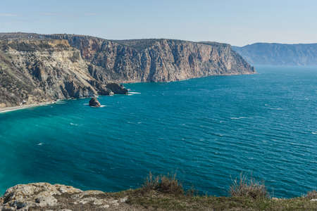 View of Crimean rugged rocky shore with Saint George Monastery and rock of Holy Apparition from Cape Fiolent in spring sunny day. Sevastopol, Crimeaの写真素材