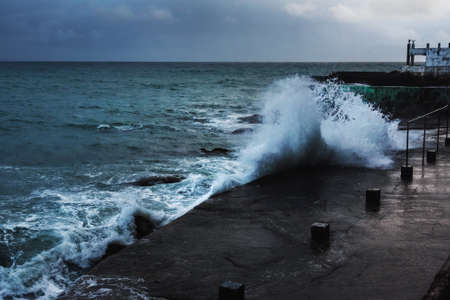 Storm at Black sea in spring. Sea view with waves during rain and cloudy in Alupka. Crimea