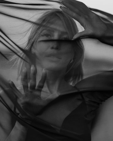 Portrait of woman under transparent textile. black and whiteの写真素材