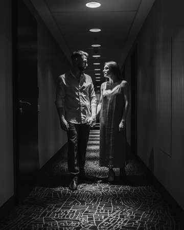 Young couple in love walking along the corridor of the hotel. black and whiteの写真素材
