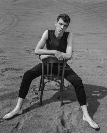 Lone Man sitting on chair in desert. black and whiteの写真素材