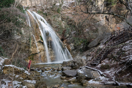 Djur-Djur waterfall in early spring with snow. Khapkhalskiy canyon in Crimeaの写真素材