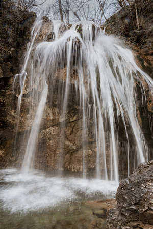Djur-Djur waterfall in early spring with snow. Khapkhalskiy canyon in Crimeaの写真素材