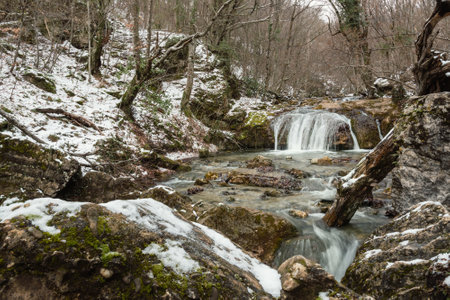 Cascades of Djur-Djur waterfall on Ulu-Uzen river in early spring with snow. Khapkhalskiy canyon in Crimeaの写真素材